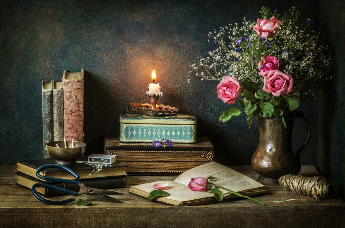 still life with vintage books with pink rose